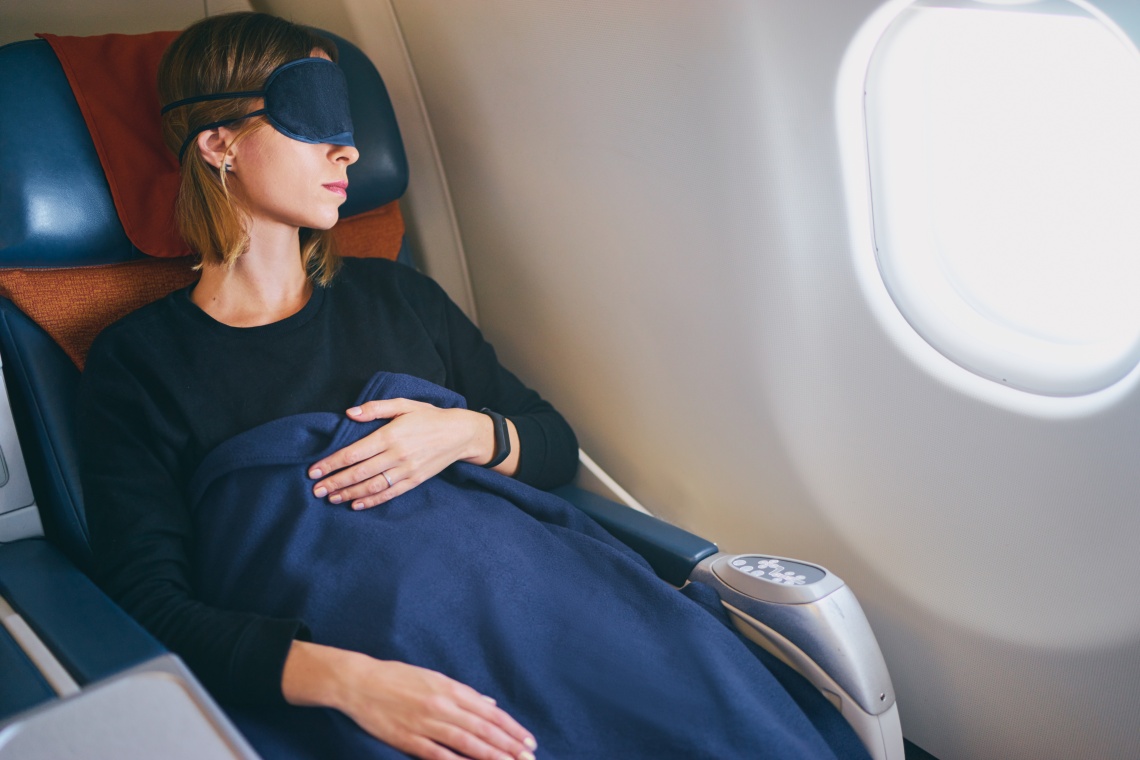 Young woman sleeping in airplane.